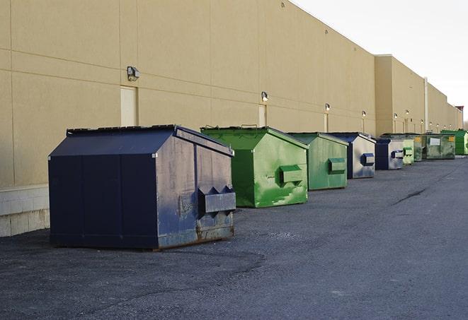 multiple construction dumpsters at a worksite holding various types of debris in Bound Brook